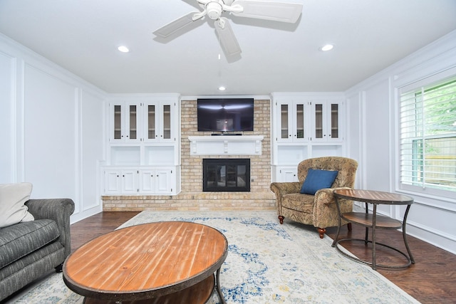 14619 Rosehill Dr, Houston, TX 77070 - living room featuring wood finished floors, a brick fireplace, ceiling fan, recessed lighting, and baseboards