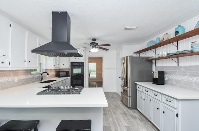 14619 Rosehill Dr, Houston, TX 77070 - kitchen featuring island range hood, a sink, black appliances, open shelves, and light wood-type flooring