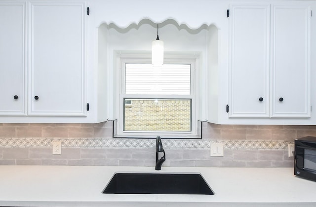 14619 Rosehill Dr, Houston, TX 77070 - kitchen featuring a sink, light countertops, and white cabinetry