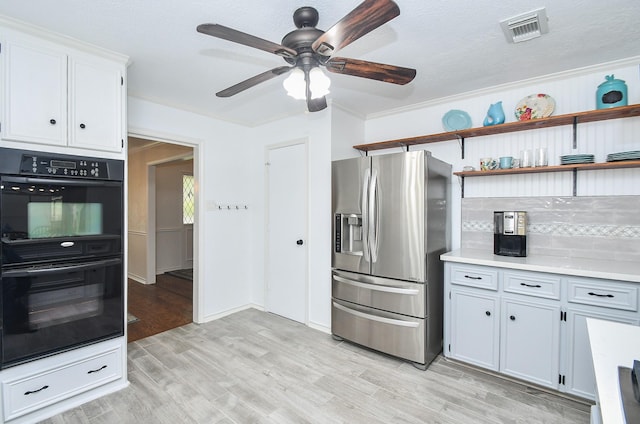 14619 Rosehill Dr, Houston, TX 77070 - kitchen with stainless steel fridge, ceiling fan, light wood finished floors, light countertops, and backsplash