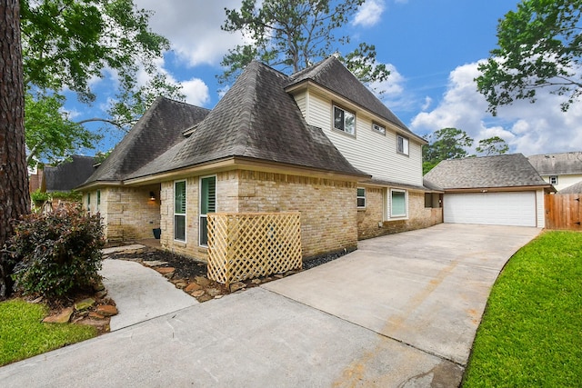 14619 Rosehill Dr, Houston, TX 77070 - view of side of home with driveway, brick siding, roof with shingles, and an attached garage