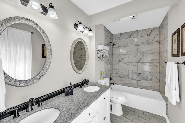 bathroom featuring bathing tub / shower combination, toilet, double vanity, and a sink