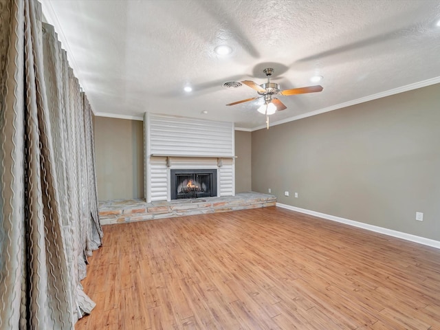 208 Burnett Dr, Baytown, TX 77520 - unfurnished living room featuring a ceiling fan, baseboards, a textured ceiling, and light wood-type flooring