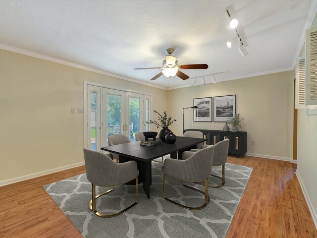 208 Burnett Dr, Baytown, TX 77520 - dining room featuring a ceiling fan, rail lighting, baseboards, and light wood-style floors