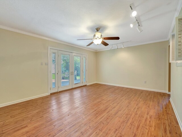 208 Burnett Dr, Baytown, TX 77520 - spare room with rail lighting, a ceiling fan, baseboards, light wood-type flooring, and ornamental molding