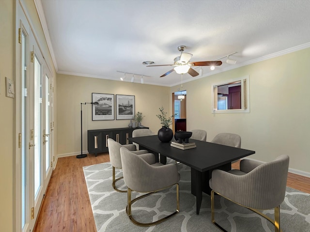 208 Burnett Dr, Baytown, TX 77520 - dining space with a ceiling fan, rail lighting, baseboards, light wood-style floors, and ornamental molding