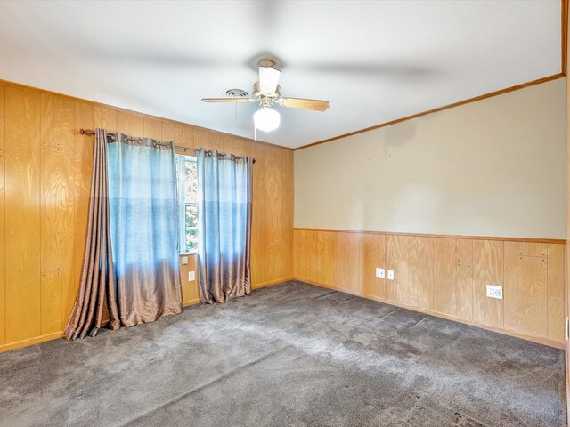 208 Burnett Dr, Baytown, TX 77520 - unfurnished room with a ceiling fan, wood walls, ornamental molding, and carpet