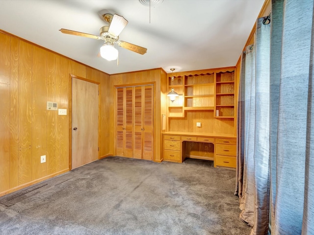 208 Burnett Dr, Baytown, TX 77520 - unfurnished bedroom featuring carpet flooring, wood walls, built in study area, and a closet