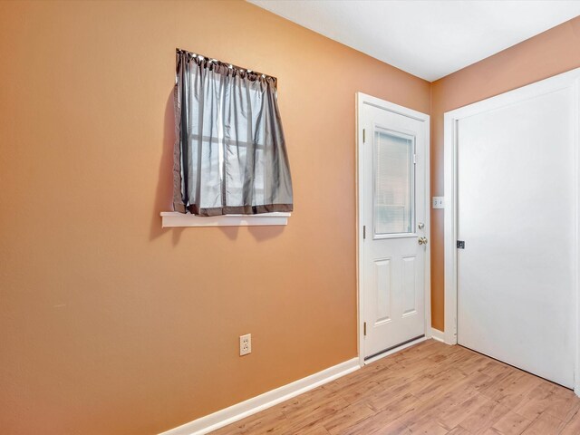 208 Burnett Dr, Baytown, TX 77520 - foyer with baseboards and light wood-style flooring