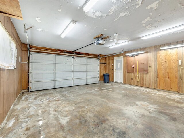208 Burnett Dr, Baytown, TX 77520 - garage featuring a garage door opener and wood walls