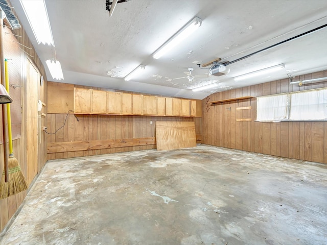 208 Burnett Dr, Baytown, TX 77520 - garage featuring wood walls and a garage door opener