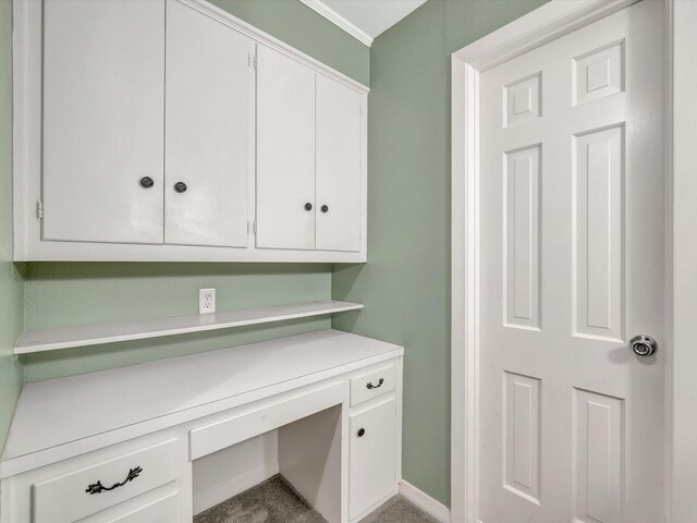 208 Burnett Dr, Baytown, TX 77520 - unfurnished office with carpet floors, baseboards, ornamental molding, and built in desk