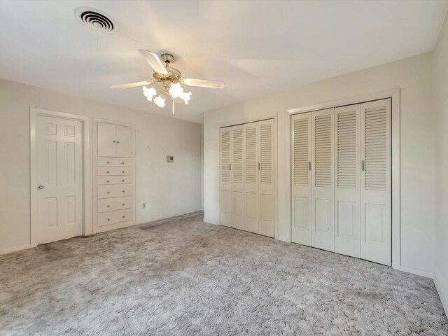 208 Burnett Dr, Baytown, TX 77520 - unfurnished bedroom with ceiling fan, multiple closets, carpet, and visible vents
