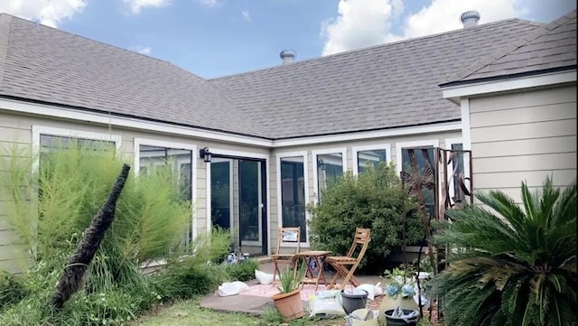 2707 Terrace Cir, West Orange, TX 77630 - rear view of house featuring roof with shingles