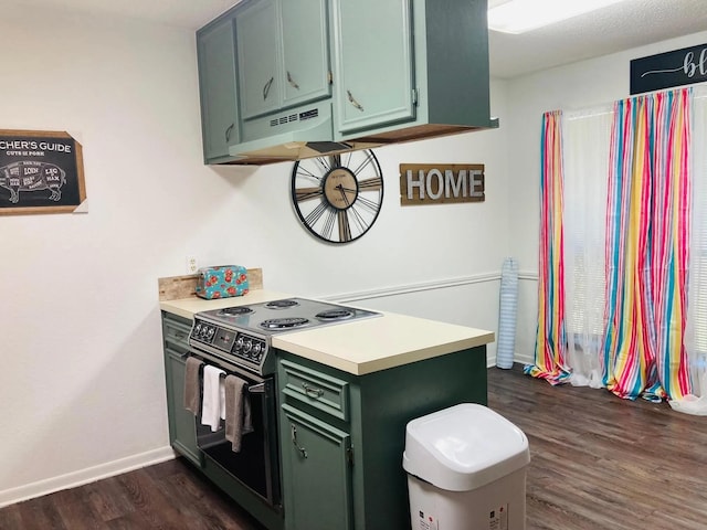 2707 Terrace Cir, West Orange, TX 77630 - kitchen with green cabinetry, electric range, under cabinet range hood, light countertops, and dark wood-style flooring