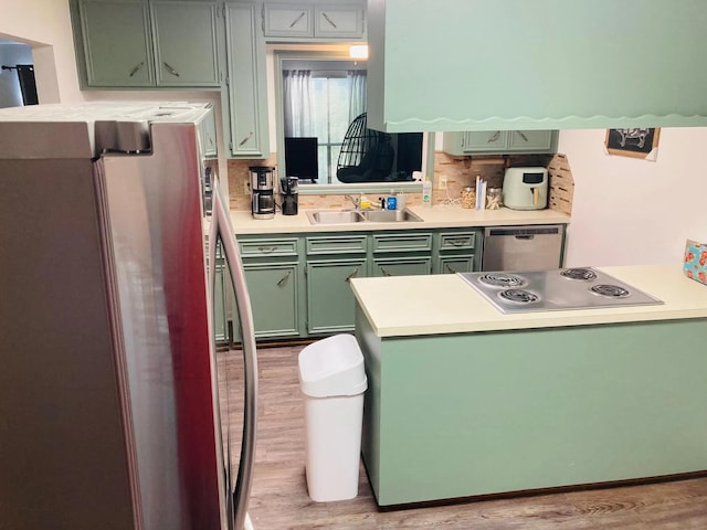 2707 Terrace Cir, West Orange, TX 77630 - kitchen featuring green cabinetry, stainless steel appliances, light wood finished floors, and a sink