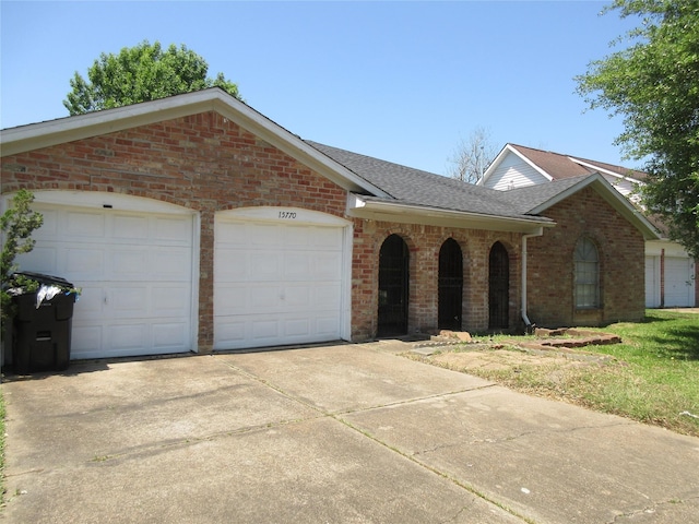 15770 Chimney Rock Rd, Houston, TX 77489 - ranch-style home with concrete driveway, roof with shingles, a garage, and brick siding