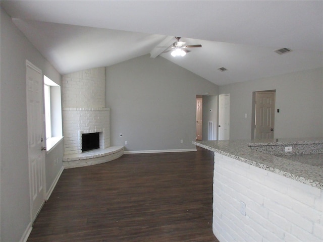 15770 Chimney Rock Rd, Houston, TX 77489 - unfurnished living room with dark wood-style floors, a fireplace, vaulted ceiling with beams, a ceiling fan, and visible vents