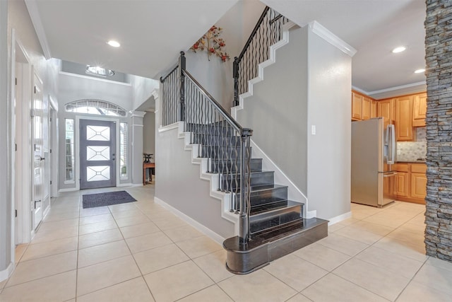 16015 Maycrest Ct, Tomball, TX 77377 - foyer entrance featuring light tile patterned floors, crown molding, and stairway