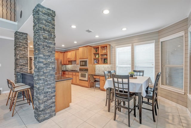 16015 Maycrest Ct, Tomball, TX 77377 - kitchen featuring decorative columns, visible vents, dark countertops, appliances with stainless steel finishes, and open shelves