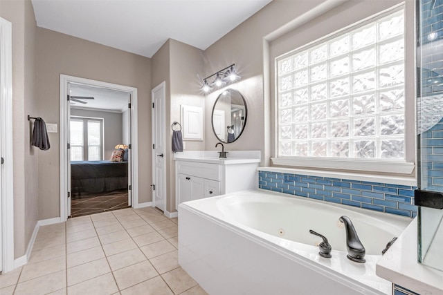 16015 Maycrest Ct, Tomball, TX 77377 - full bathroom featuring tile patterned flooring, a tub with jets, baseboards, vanity, and ensuite bath