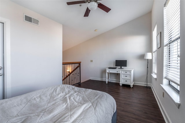 bedroom with baseboards, dark wood-style floors, visible vents, a ceiling fan, and high vaulted ceiling