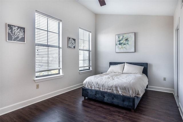 bedroom with baseboards, ceiling fan, lofted ceiling, and dark wood-type flooring