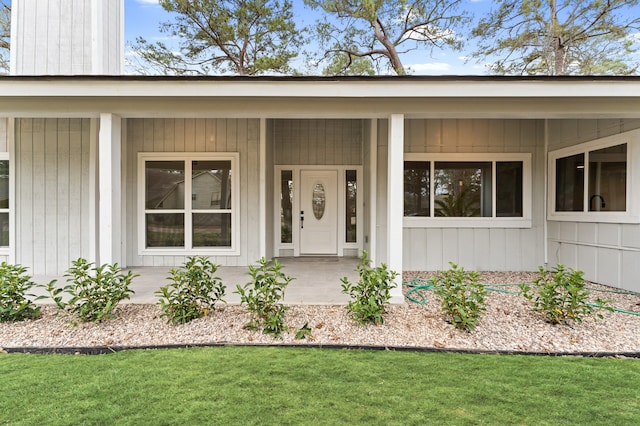 view of exterior entry featuring a porch