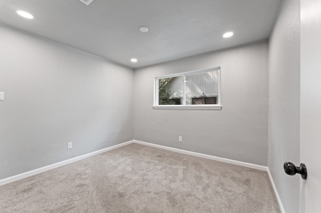 carpeted spare room featuring recessed lighting and baseboards