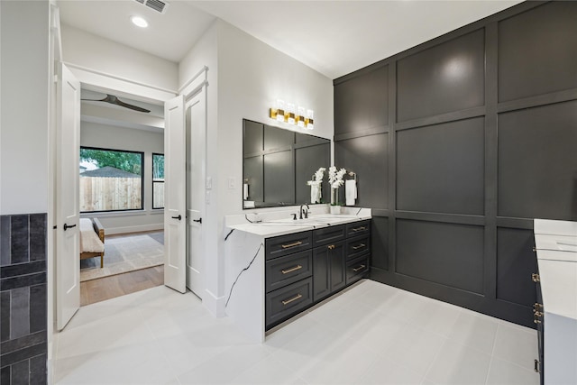 ensuite bathroom with connected bathroom, recessed lighting, a decorative wall, vanity, and a ceiling fan