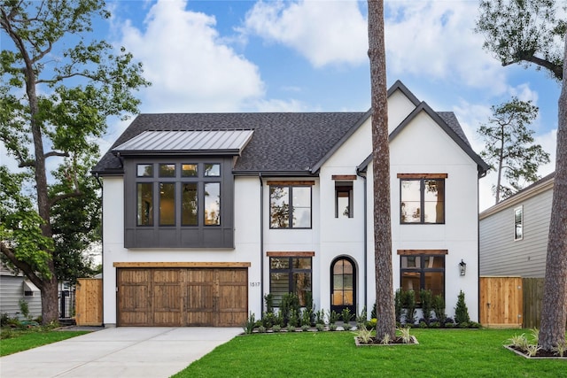 view of front of house with driveway, stucco siding, and fence