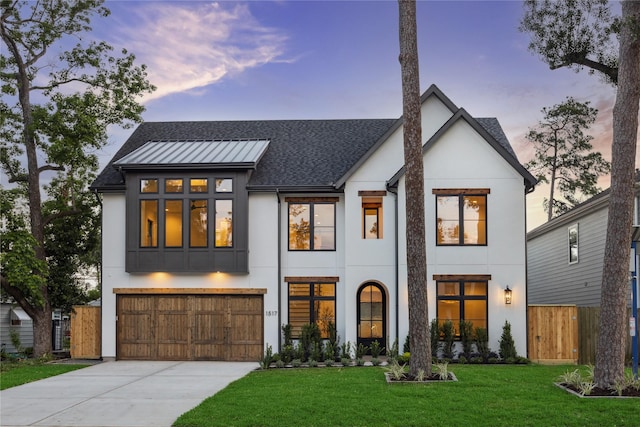view of front of home featuring driveway, fence, a lawn, an attached garage, and stucco siding