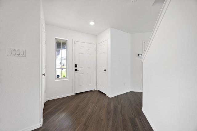 entryway featuring baseboards and dark wood-style floors