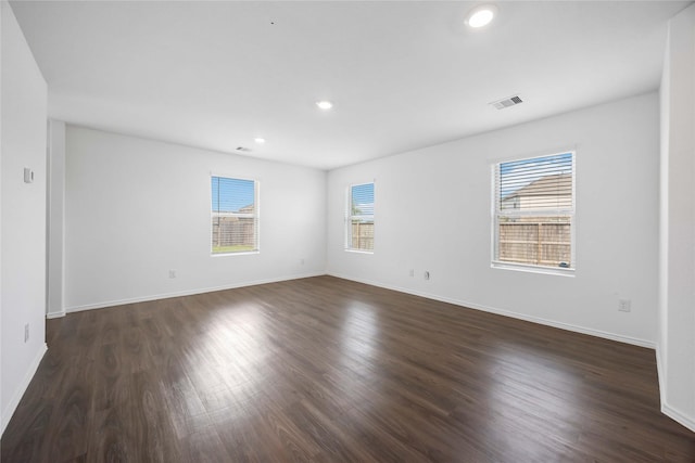 unfurnished room with dark wood finished floors, recessed lighting, and visible vents
