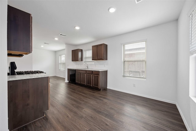 kitchen with visible vents, dark brown cabinets, light countertops, baseboards, and dark wood-style floors