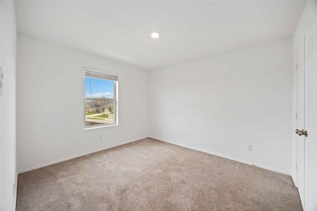 carpeted spare room with baseboards