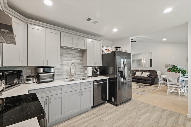 kitchen with stainless steel appliances, light countertops, backsplash, a sink, and visible vents