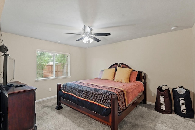 carpeted bedroom with baseboards and ceiling fan