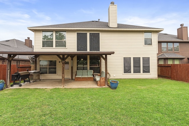 21735 Lozar Dr, Spring, TX 77379 - back of house with a lawn, a chimney, a fenced backyard, and a patio area