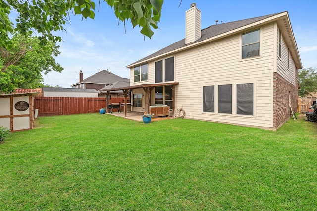21735 Lozar Dr, Spring, TX 77379 - rear view of property featuring a fenced backyard, a patio, a chimney, and a hot tub