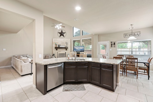 21735 Lozar Dr, Spring, TX 77379 - kitchen with plenty of natural light, dark brown cabinetry, stainless steel dishwasher, a sink, and open floor plan