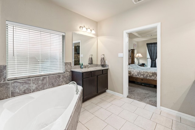 21735 Lozar Dr, Spring, TX 77379 - ensuite bathroom featuring a garden tub, vanity, baseboards, connected bathroom, and tile patterned floors
