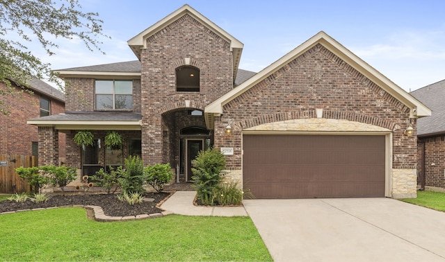 21735 Lozar Dr, Spring, TX 77379 - view of front facade featuring concrete driveway, brick siding, and an attached garage