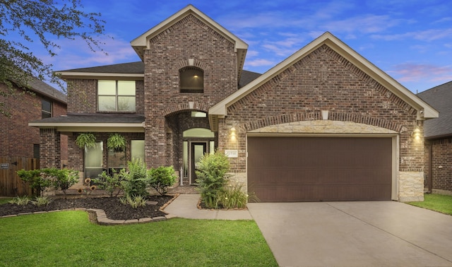 21735 Lozar Dr, Spring, TX 77379 - view of front facade featuring a shingled roof, an attached garage, brick siding, a front yard, and driveway