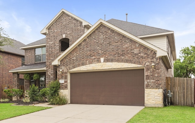 21735 Lozar Dr, Spring, TX 77379 - view of front of home with concrete driveway, brick siding, fence, and a garage
