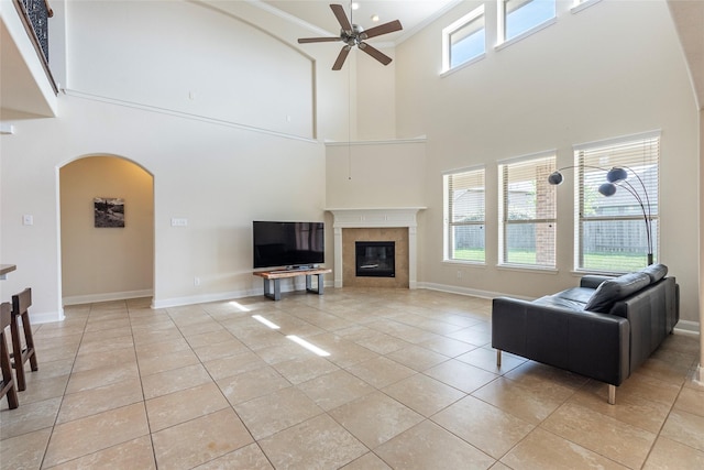 2623 Holbrook Springs Ln, League City, TX 77573 - living area with light tile patterned flooring, a towering ceiling, a ceiling fan, and arched walkways