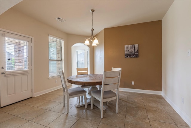 2623 Holbrook Springs Ln, League City, TX 77573 - dining room with a chandelier, light tile patterned floors, visible vents, baseboards, and arched walkways