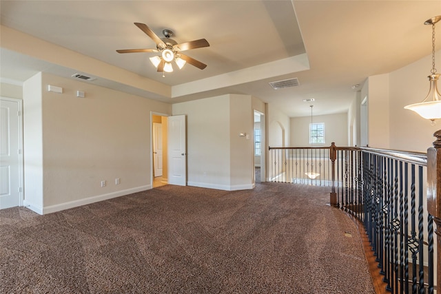 2623 Holbrook Springs Ln, League City, TX 77573 - carpeted empty room with a ceiling fan, visible vents, a raised ceiling, and baseboards