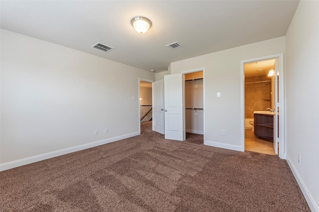 2623 Holbrook Springs Ln, League City, TX 77573 - unfurnished bedroom featuring baseboards, visible vents, a spacious closet, and carpet