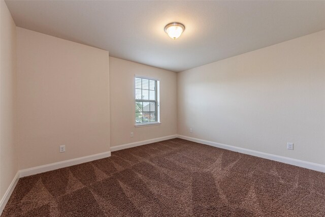 2623 Holbrook Springs Ln, League City, TX 77573 - spare room featuring dark carpet and baseboards
